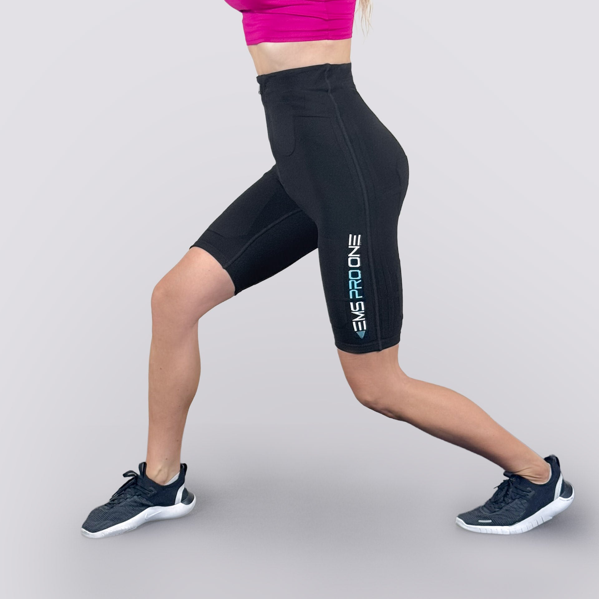 Side view of EMS PRO ONE shorts during lunge, showing logo and ergonomic fit